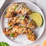 three avocado fries on white plate with drizzle of sour cream