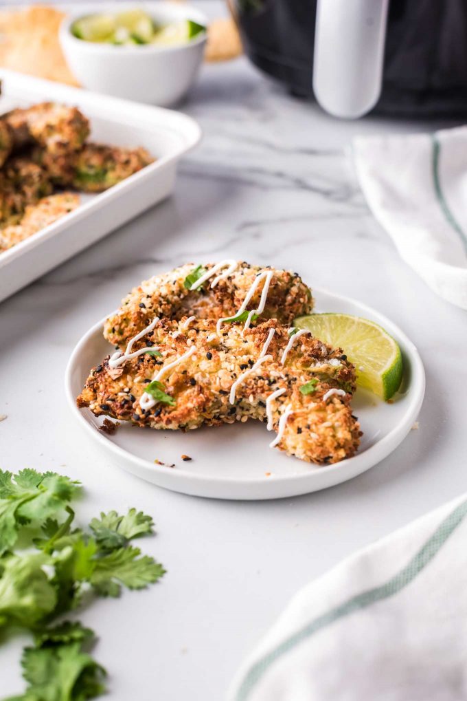 avocado fries on plate with drizzle of sour cream