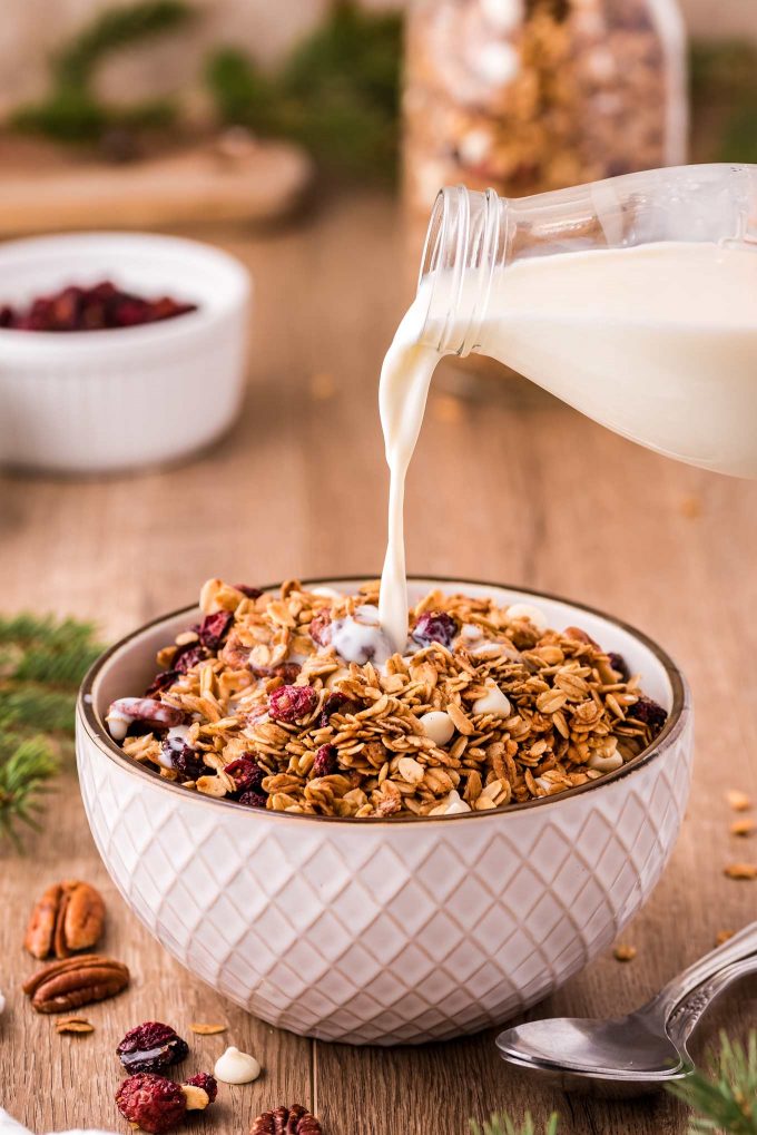 pouring milk into a bowl of granola