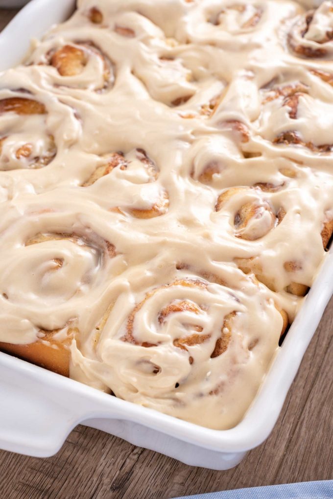 baking pan of cinnamon rolls with cream cheese icing