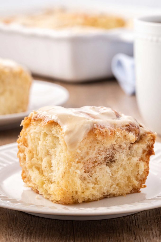 cinnamon bun on white plate with fork