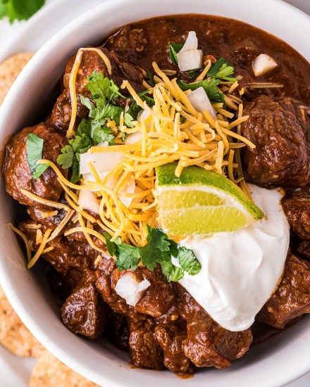 Texas-Style Chili recipe is thick and meaty, smoky and spicy.  This chili has no beans, but instead has a rich beefy gravy and chunks of seared beef that are slow simmered until perfectly tender. #texaschili #chili #nobeanchili #comfortfood #dutchoven #slowcooker