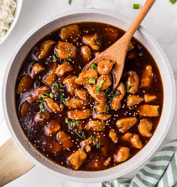 skillet full of bourbon chicken in sauce