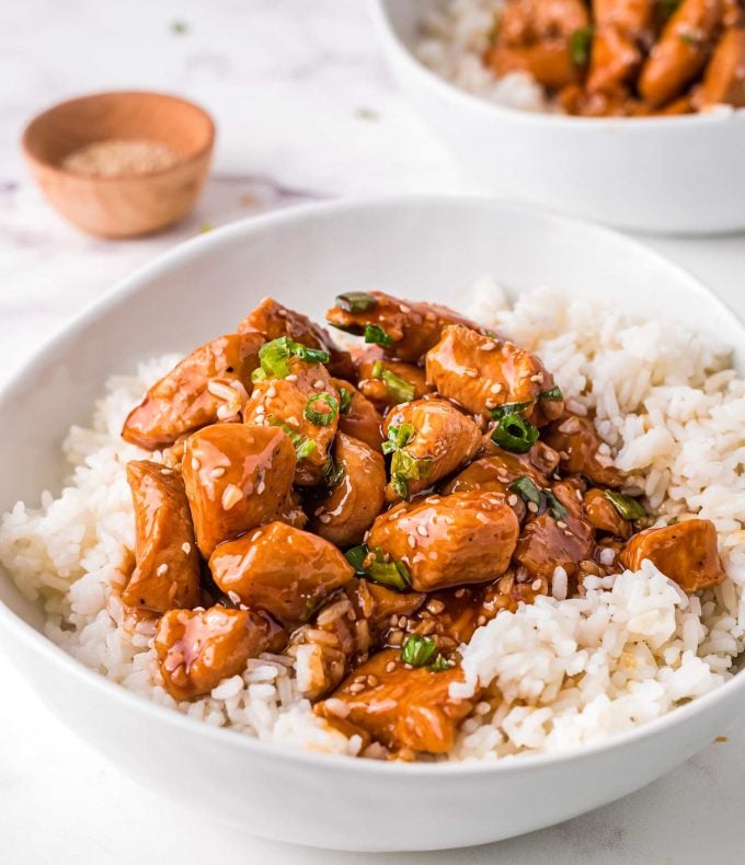 side view of bowl of rice topped with bourbon chicken