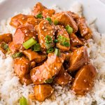 pile of bourbon chicken served over rice