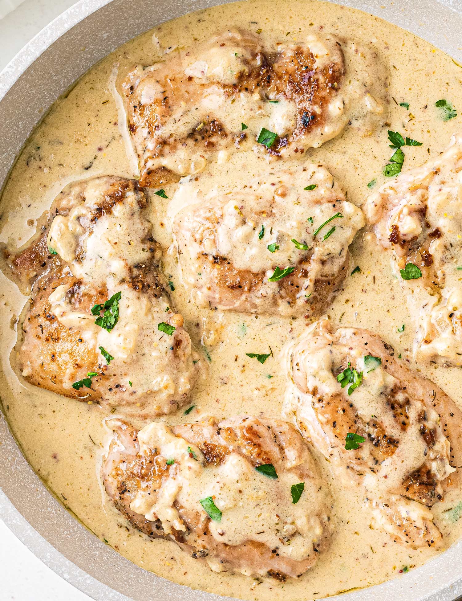 Simple and easy, these Chicken Thighs with Creamy Mustard Sauce are made in one pan, and ready in about 30-40 minutes! Packed with bold and rich flavors, this is a great weeknight dinner idea. The mustard sauce is perfect over veggies, potatoes and more! #chicken #thighs #mustard #onepan #onepot #dijonmustard #mustardsauce