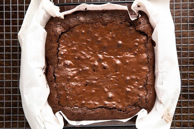 baked brownies in pan with parchment paper