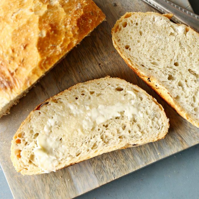 slice of no knead bread with butter on it