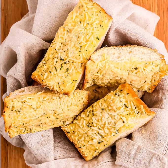 pile of garlic bread slices in bread basket