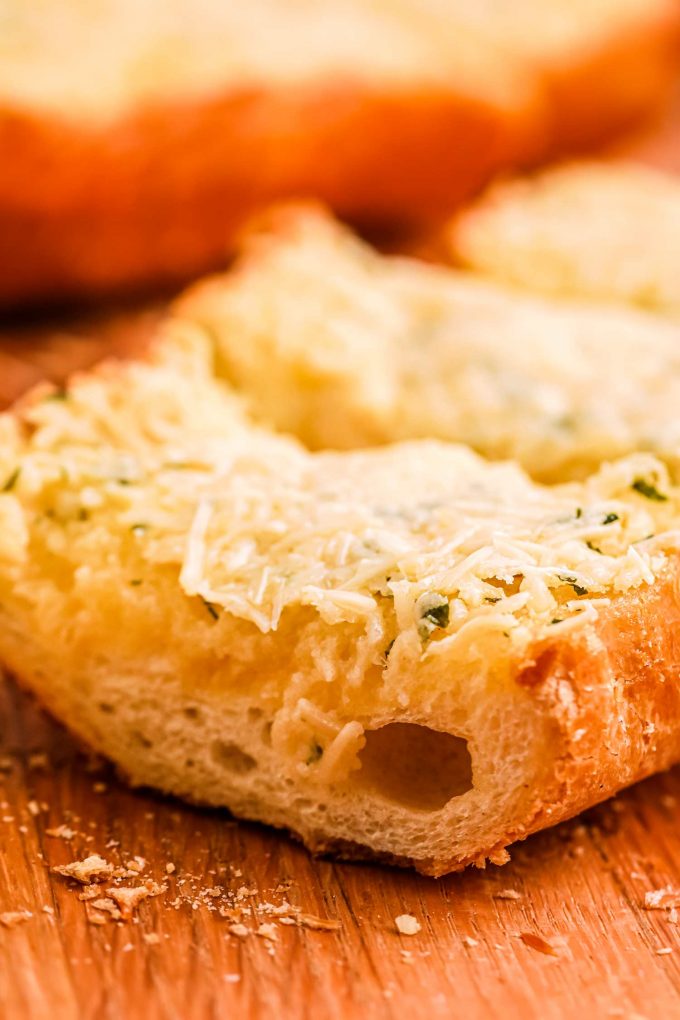 Homemade garlic bread is so simple to make!  Complete with crispy edges, buttery and soft middles and plenty of garlic and herb flavor. Frozen bread doesn’t stand a chance against this garlic bread! #garlicbread #garlic #bread #easyrecipe #homemade #cheesy #cheesybread #italian