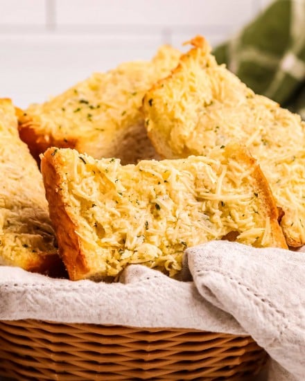 Homemade garlic bread is so simple to make! Complete with crispy edges, buttery and soft middles and plenty of garlic and herb flavor. Frozen bread doesn’t stand a chance against this garlic bread! #garlicbread #garlic #bread #easyrecipe #homemade #cheesy #cheesybread #italian