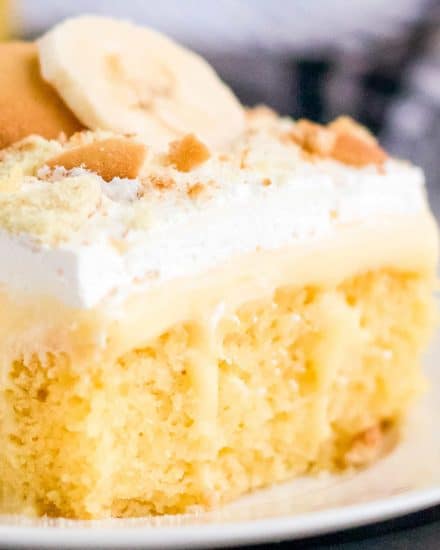 This Banana Pudding Poke Cake is the easiest and most delicious banana dessert around! Buttery yellow cake is infused with banana pudding, then slathered with whipped cream, crushed vanilla wafers and banana slices! Naturally a make ahead dessert, this is a dessert recipe the whole family will love! #pokecake #yellowcake #bananapudding #dessert #baking