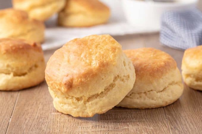 Learn how to make the BEST Buttermilk Biscuits from scratch! They're so light and flaky, and plenty fluffy. Perfect for topping with sausage gravy, butter, honey or jam! #biscuits #biscuitrecipe #buttermilkbiscuits
