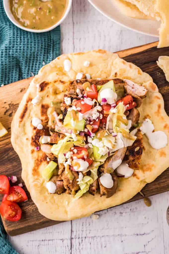 marinated chicken thighs on flatbread with vegetables