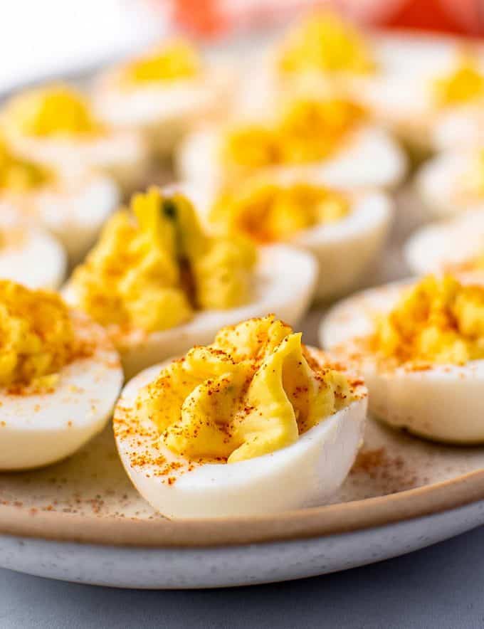 These Classic Deviled Eggs are so creamy, full of flavor, and easy to make. Perfect for a bbq, potluck, holidays, and more! This is a base recipe that you can play around with and add fun flavors to! #deviledeggs #deviled #hardboiledeggs