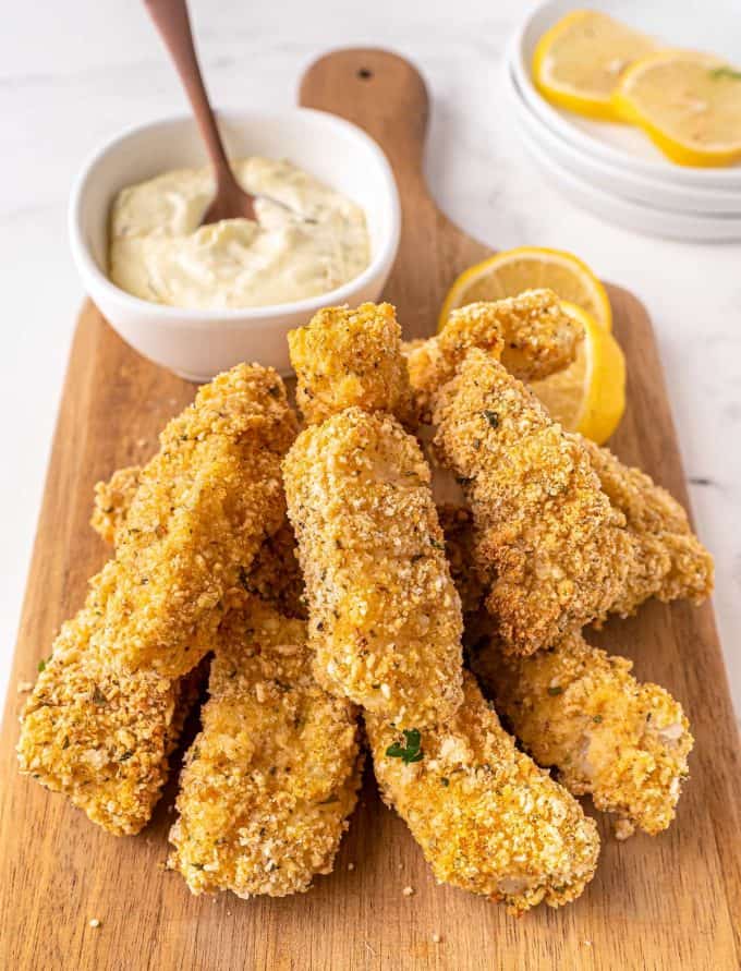 fish sticks and tartar sauce on small cutting board