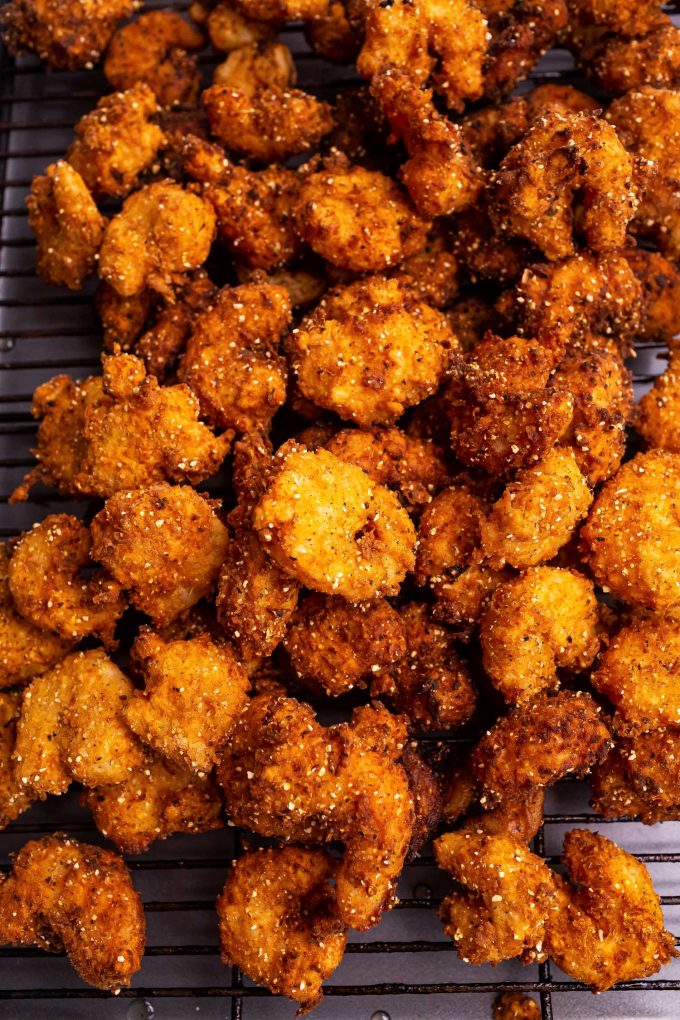 These Southern-Style Fried Shrimp are so juicy and tender, with the crispiest crust.  Deep fried in a buttermilk and flour/cornmeal batter, they're perfect with cocktail sauce as an appetizer, or a fun dinner! #shrimp #friedshrimp #popcornshrimp #seafood #southernfood 