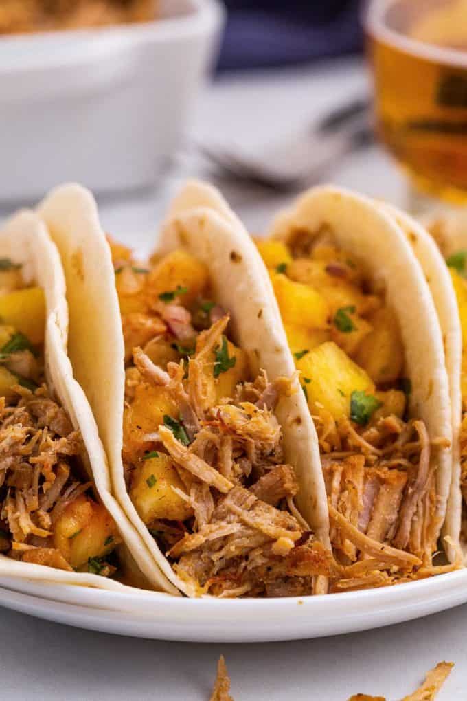 three shredded pork tacos