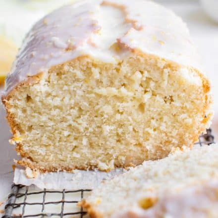 sliced loaf of lemon pound cake with glaze