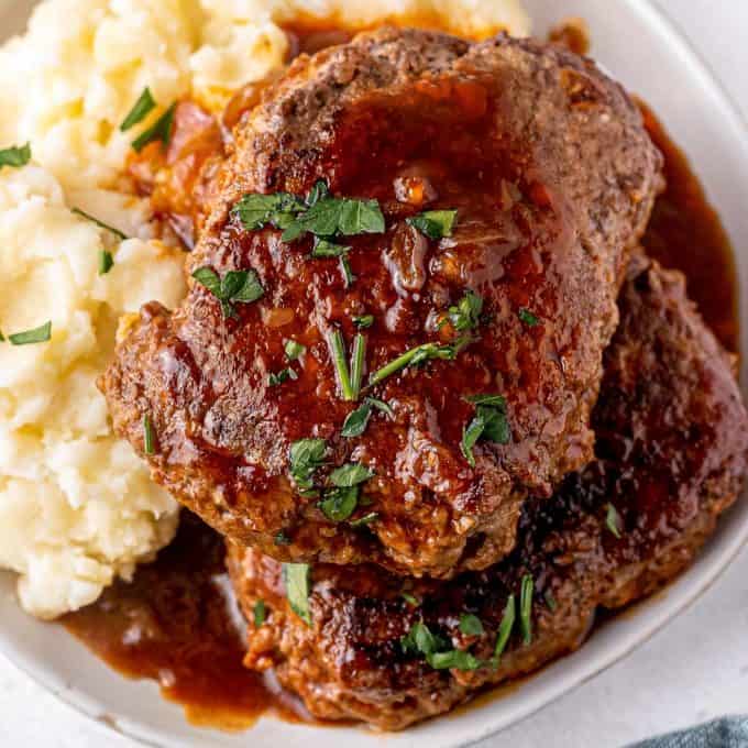 stout bbq salisbury steaks on plate with mashed potatoes