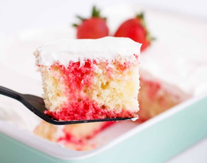 piece of strawberry poke cake on spatula