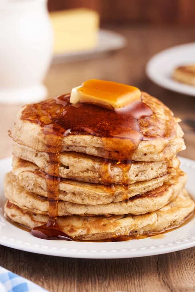 syrup poured over stack of pancakes