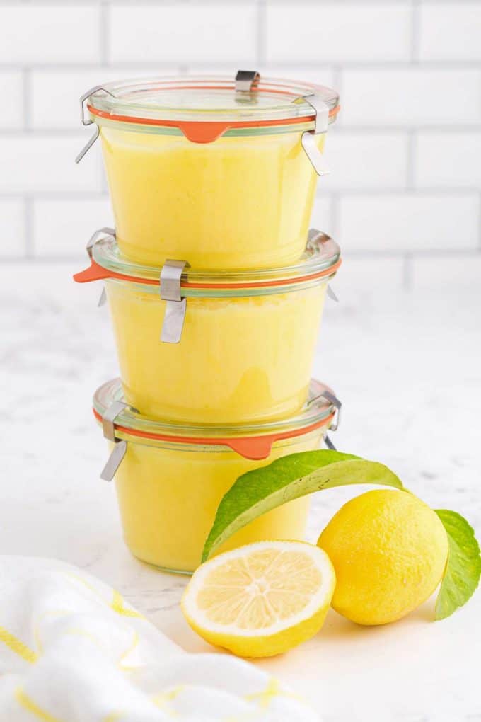 glass jars of lemon curd stacked on top of one another