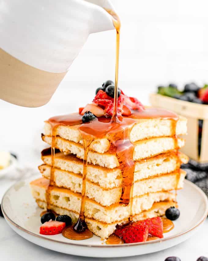 pouring syrup over sheet pan pancakes