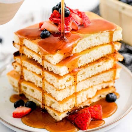 stack of sheet pan pancakes with maple syrup