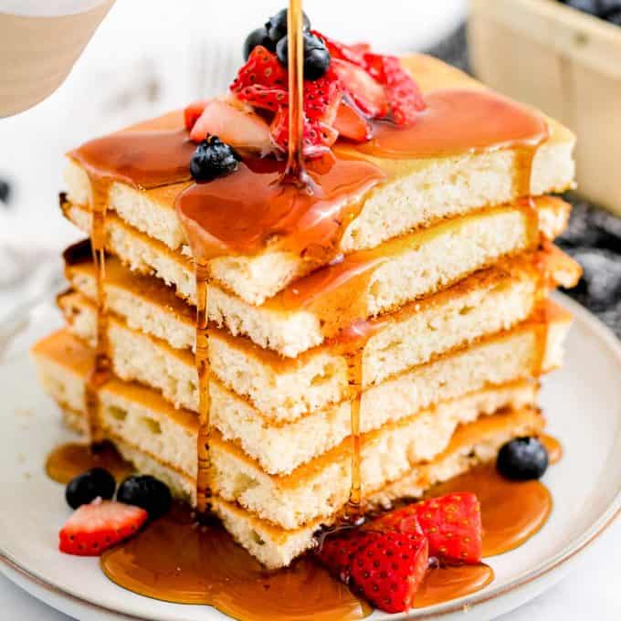 stack of sheet pan pancakes with maple syrup