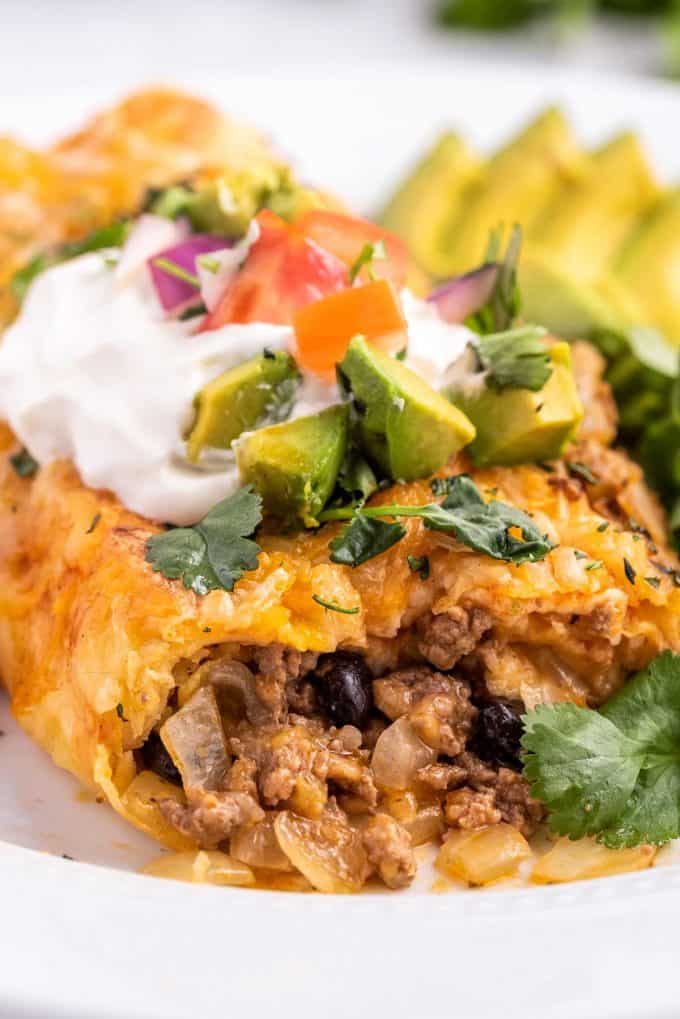 close up of cheesy ground beef filling of enchilada