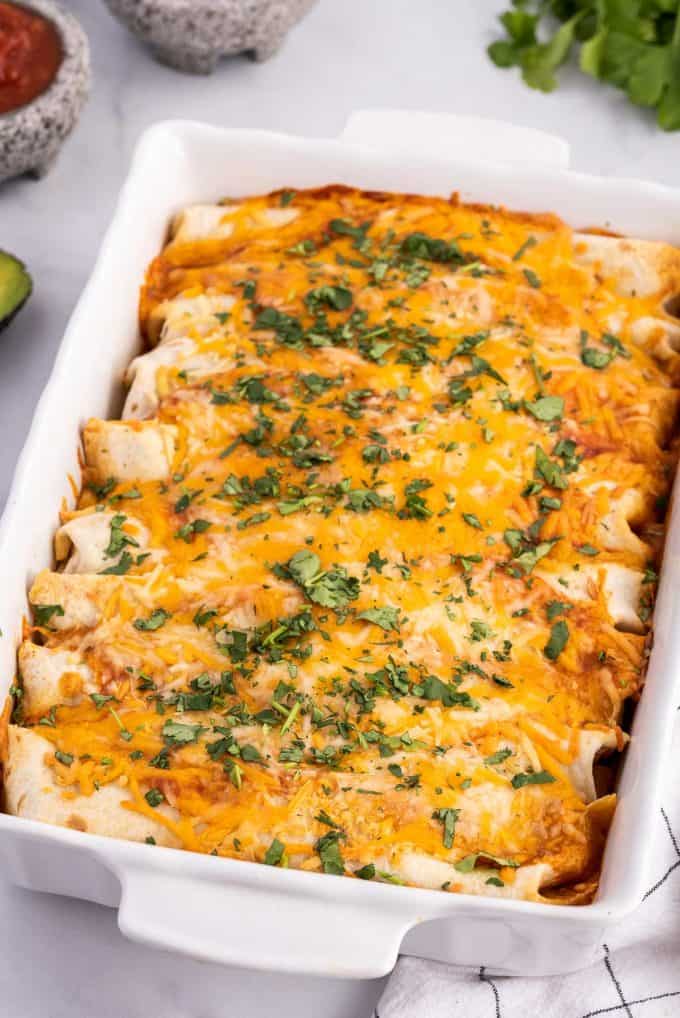 cheesy ground beef enchiladas in baking dish