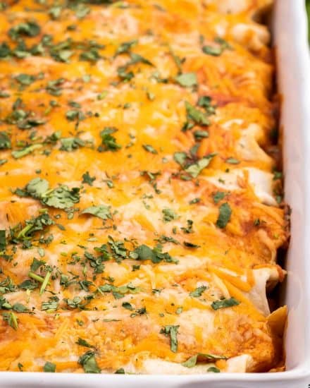These Easy Beef Enchiladas are made with a flavorful ground beef, green chiles, and black bean filling, piled high with cheese, and all smothered in a mouthwatering homemade enchilada sauce and baked to gooey cheesy perfection! #enchiladas #beef #mexican