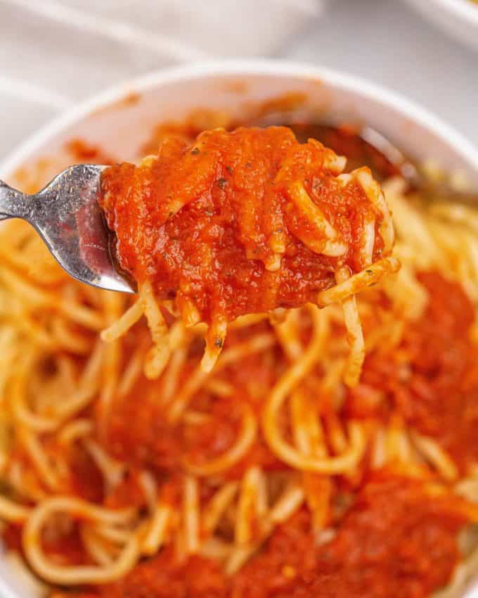 pasta twirled around a fork with pasta sauce