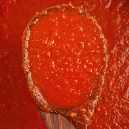 marinara sauce on wooden spoon