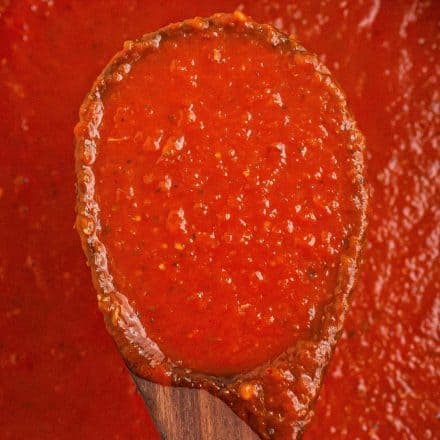 marinara sauce on wooden spoon