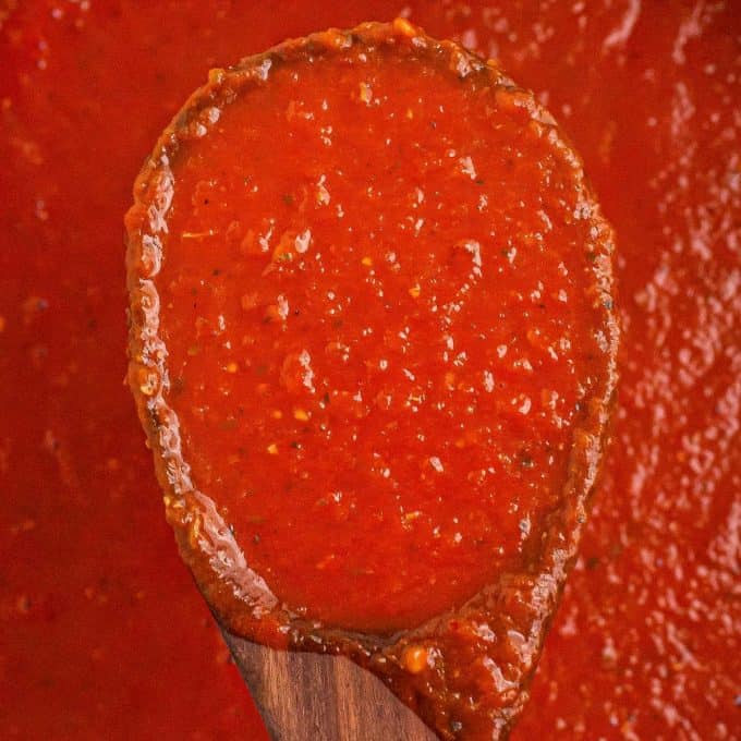 marinara sauce on wooden spoon