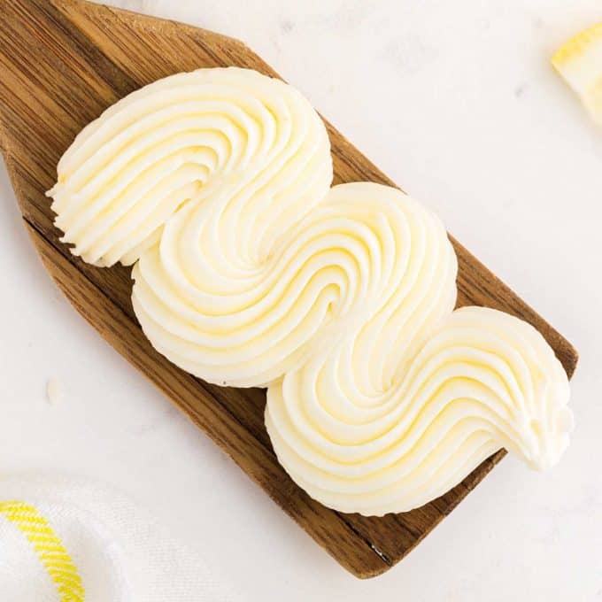 swirl of lemon buttercream on wooden spatula