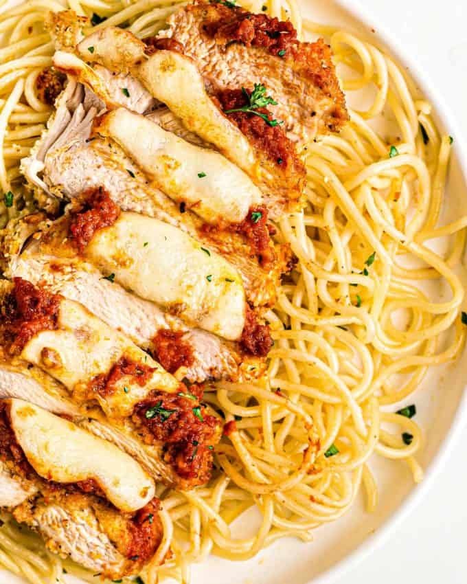 sliced chicken parmesan with spaghetti