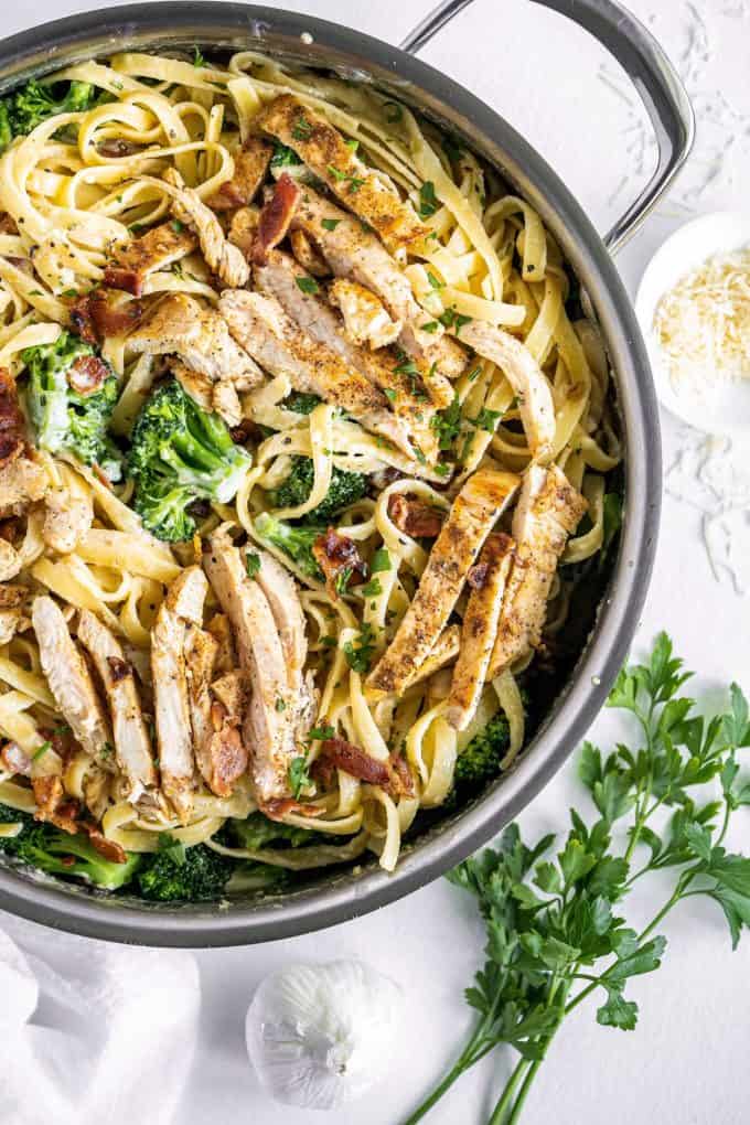 overhead view of fettuccine alfredo with chicken in skillet