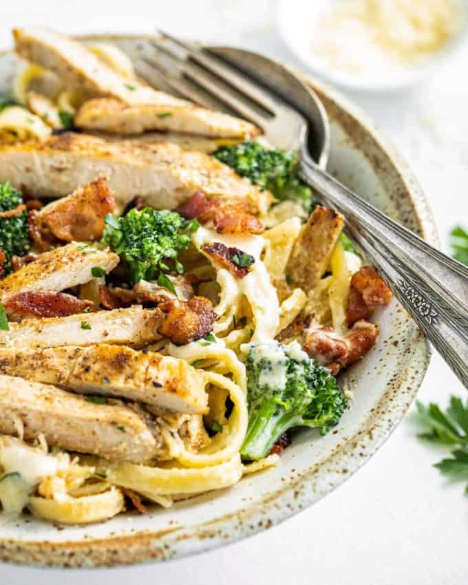 bowl of chicken fettuccine alfredo with bacon and broccoli