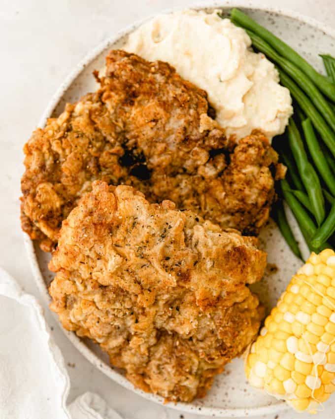 two chicken fried steaks on plate