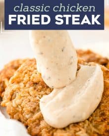 Chicken Fried Steak is a southern classic made with tender marinated cube steaks that have been breaded and pan fried until golden. And don't forget the creamy white pepper gravy on top! Restaurant-quality, but made easily at home. #chickenfriedsteak #beef #dinner #comfortfood