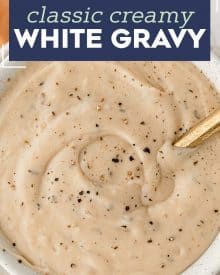 This classic White Gravy is ultra creamy, and speckled with plenty of black pepper. Perfect on chicken fried steak, fried chicken, mashed potatoes, biscuits and more! Easy to make with only 7 ingredients (including salt and pepper!). #gravy #whitegravy #peppergravy