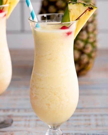 This Frozen Pina Colada is sweet, tropical, and perfect for a hot summer day! Easy to substitute with alternate rums, or even make it a virgin mocktail. #pinacolada #frozencocktail