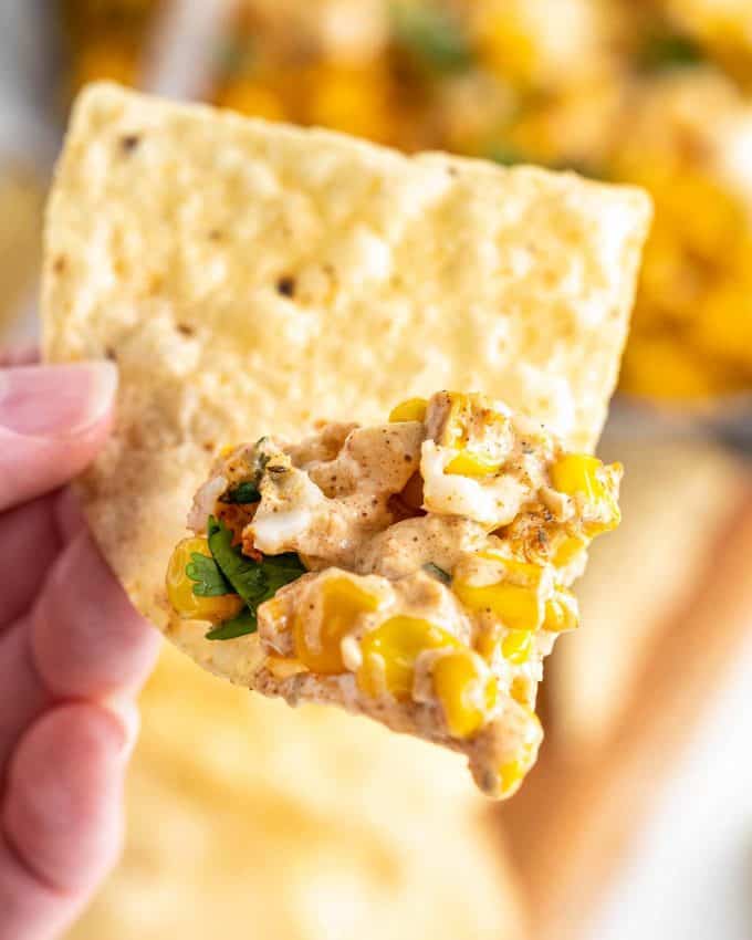 tortilla chip with scoop of elote dip