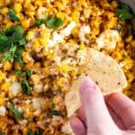 dipping chip into hot street corn dip