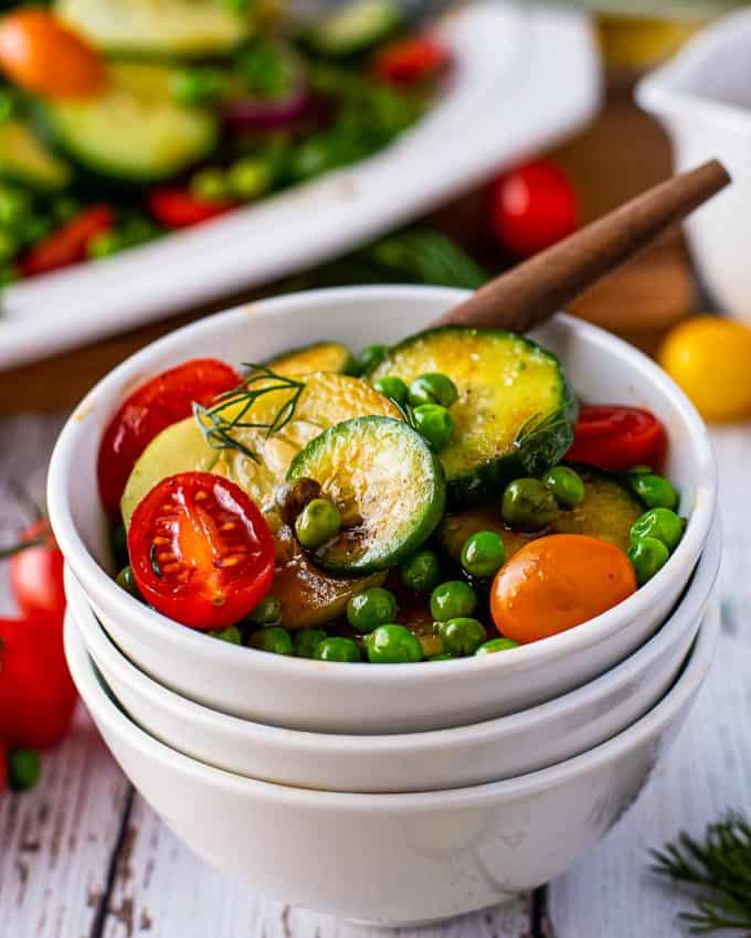 cucumber salad in white bowl.