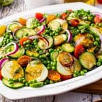 This easy mayo-free Cucumber Salad is complete with not only fresh cucumbers, but also sweet peas, crunchy red onion, tangy tomatoes, fresh herbs and a simple balsamic vinaigrette dressing. Perfect alongside a light summer meal or at a potluck! #cucumber #salad #summer