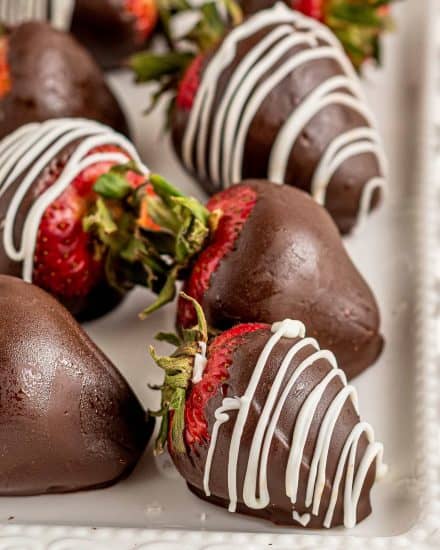 Learn how to make classic Chocolate Covered Strawberries at home, using just 4 simple ingredients and minimal effort! Plus directions for different topping options and how to make a fun boozy version! #strawberries #chocolate #dessert #nobake